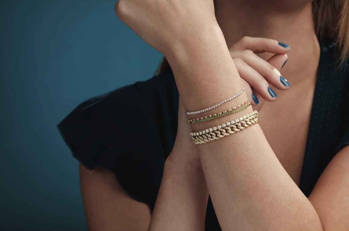 Close-up of a wrist adorned with elegant gold bracelets.