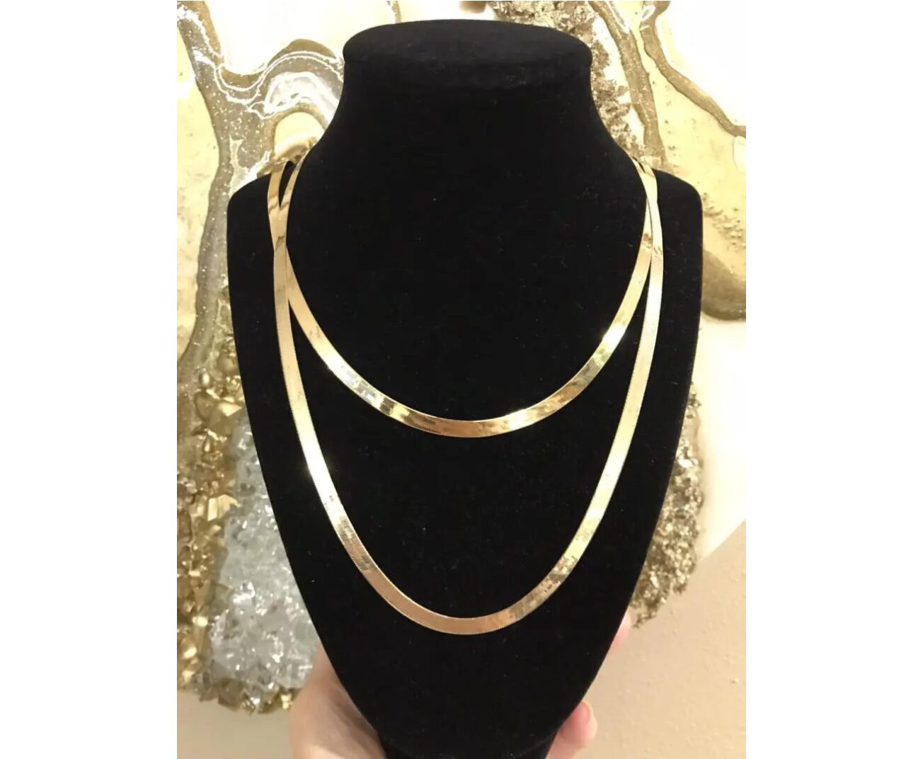 A gold necklace with a unique design